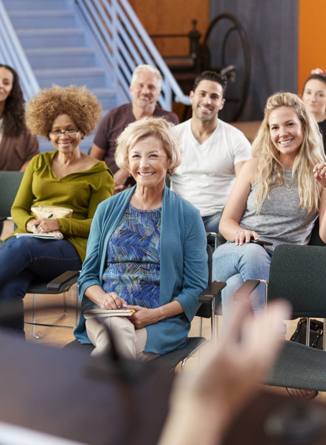 Group Attending Neighborhood Meeting Listening To Speaker In Community Center